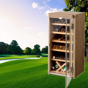 Wooden cigar station with glass door displaying multiple shelves of cigars on a golf course landscape background.